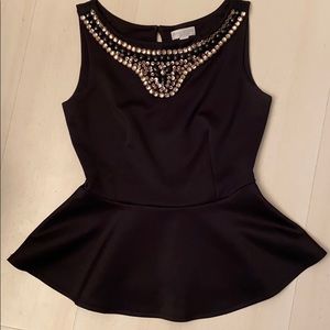 Black peplum blouse with neckline embellishments